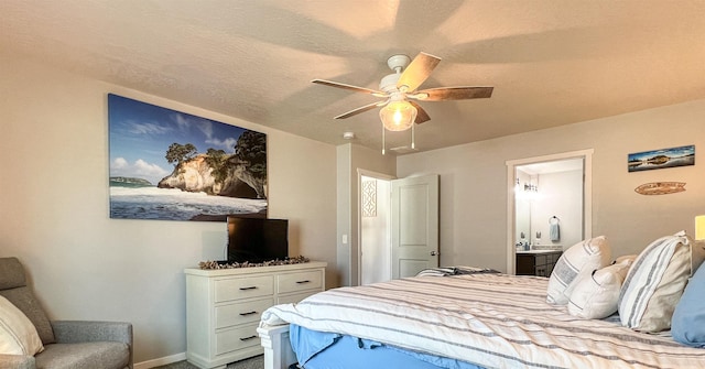 bedroom with connected bathroom, baseboards, and ceiling fan