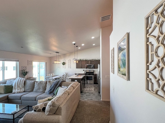 living area featuring recessed lighting, visible vents, and dark carpet