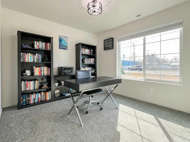 carpeted office with visible vents and baseboards