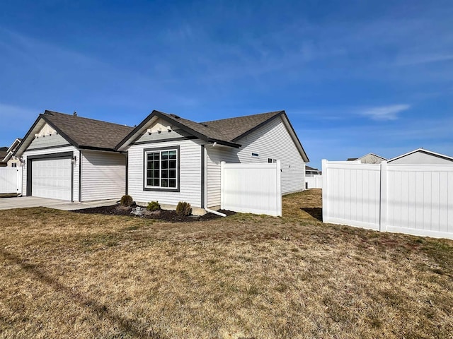 view of home's exterior featuring a yard, a garage, and fence