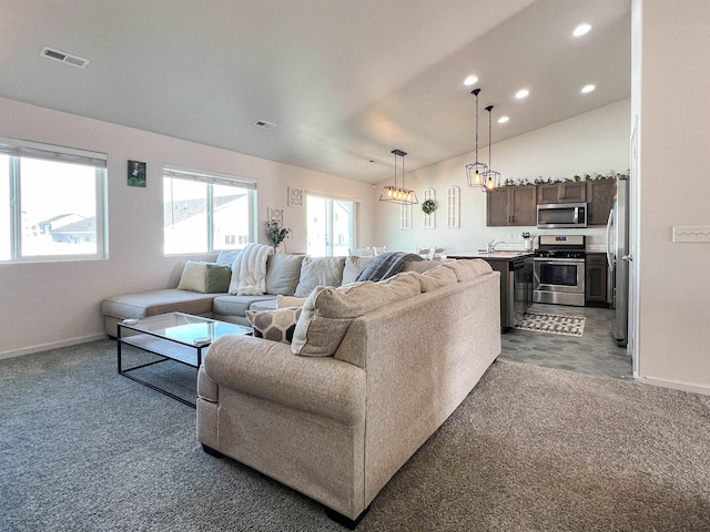 carpeted living area featuring recessed lighting, visible vents, baseboards, and vaulted ceiling