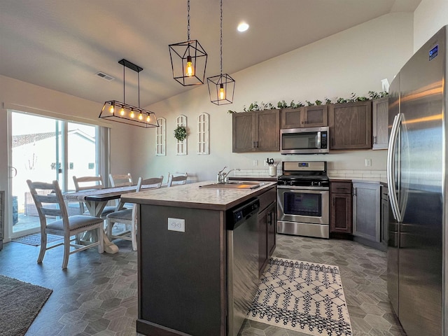 kitchen featuring visible vents, dark brown cabinets, a center island with sink, appliances with stainless steel finishes, and a sink