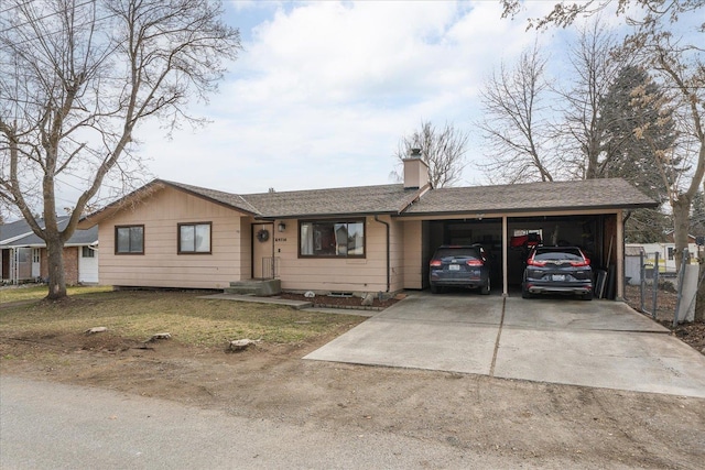 single story home with an attached carport, driveway, a chimney, and a shingled roof