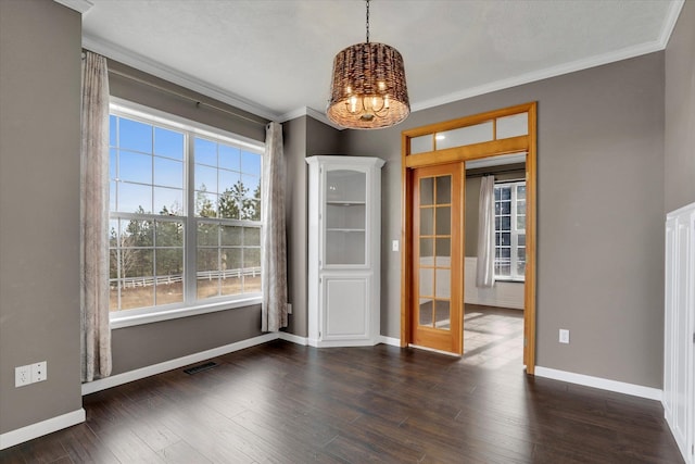 unfurnished dining area with crown molding, a healthy amount of sunlight, and dark wood-style flooring