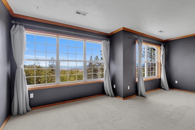 carpeted empty room with crown molding, baseboards, and visible vents