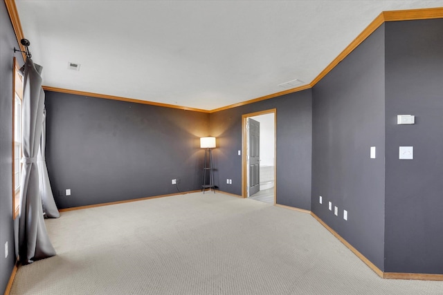 carpeted spare room featuring baseboards, visible vents, and ornamental molding