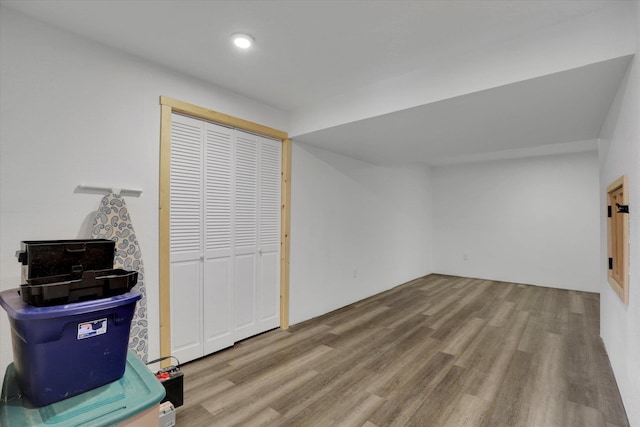 additional living space with recessed lighting and wood finished floors