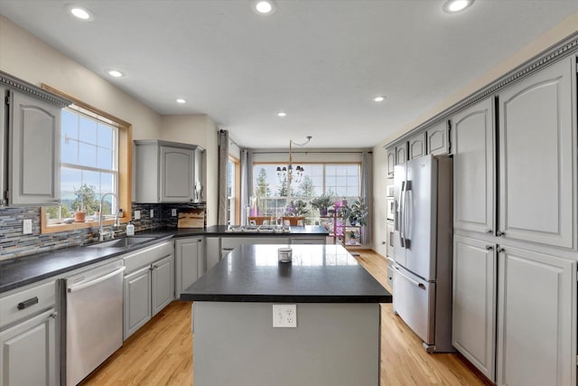 kitchen with dishwasher, dark countertops, white refrigerator with ice dispenser, and gray cabinets