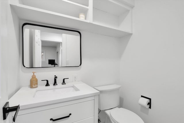 half bathroom featuring toilet and vanity