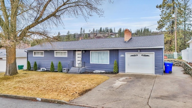 ranch-style home featuring fence, roof with shingles, an attached garage, a chimney, and concrete driveway