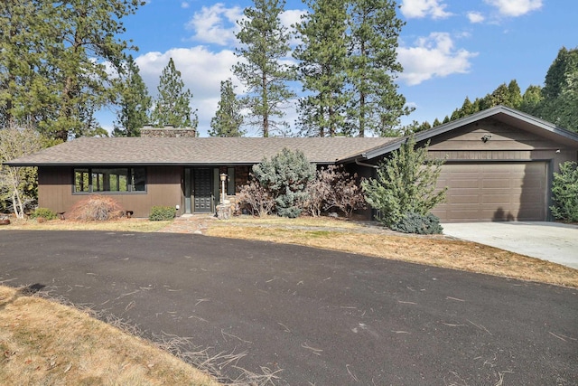 ranch-style house with an attached garage and driveway