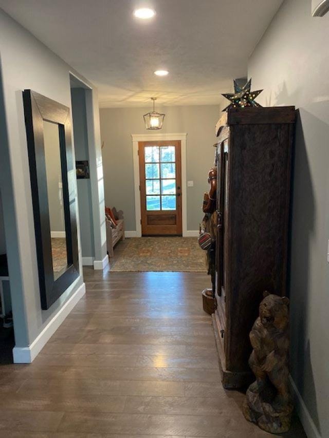 interior space with baseboards and wood finished floors