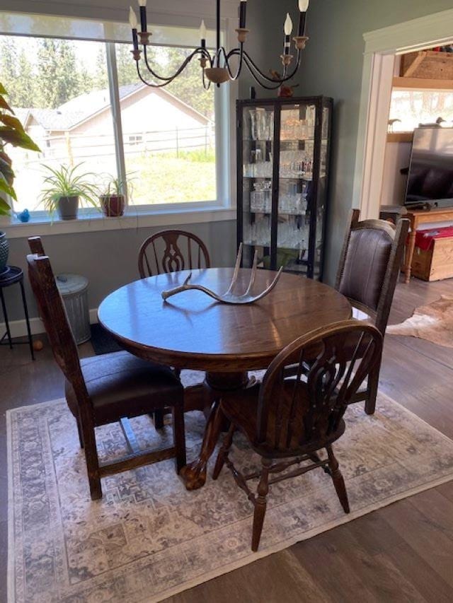 dining space with wood finished floors