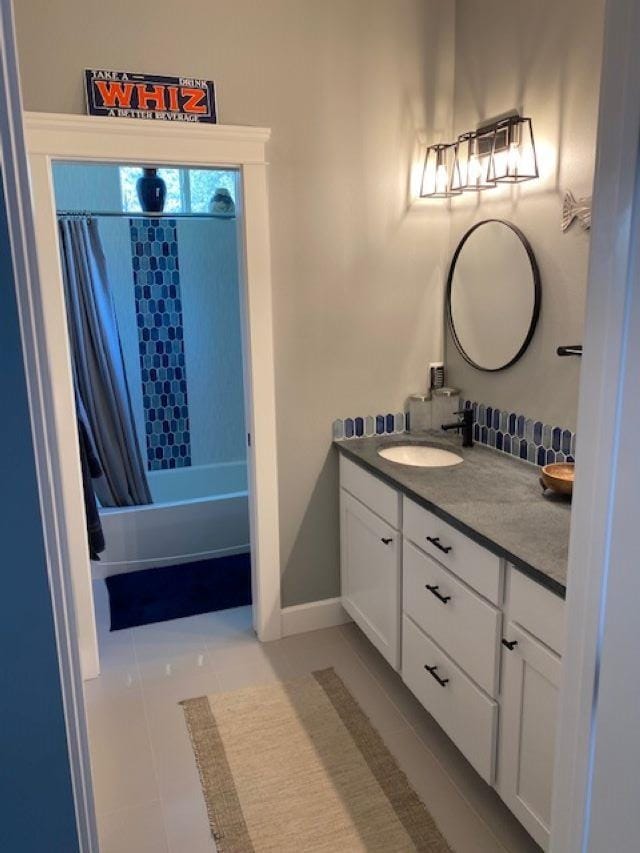 bathroom featuring vanity, tile patterned floors, baseboards, and shower / tub combo with curtain