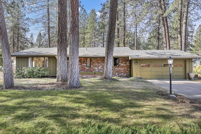 ranch-style house with brick siding, an attached garage, driveway, and a front yard