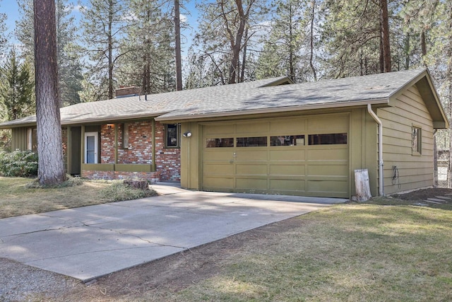 ranch-style home featuring brick siding, an attached garage, a chimney, and driveway