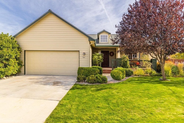 view of front facade with a front lawn, an attached garage, and concrete driveway