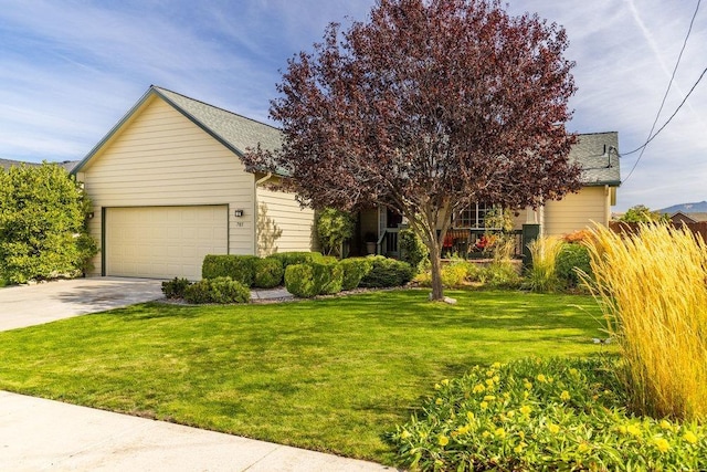 obstructed view of property with a front yard, an attached garage, concrete driveway, and a shingled roof