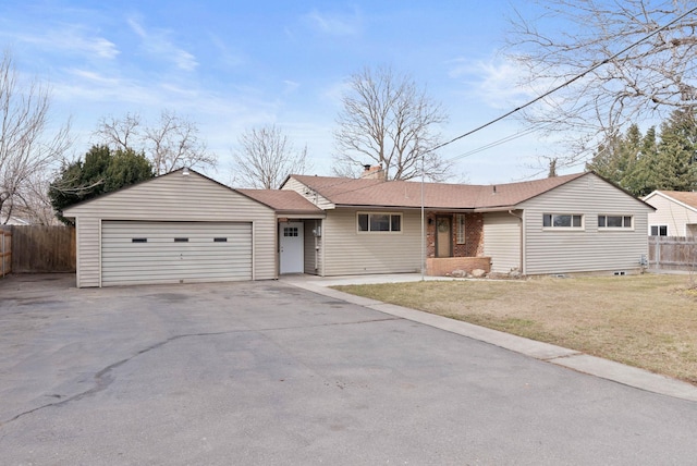 ranch-style house featuring an attached garage, a chimney, a front yard, and fence