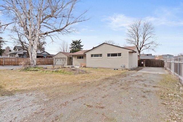 view of front of house with a garage and fence