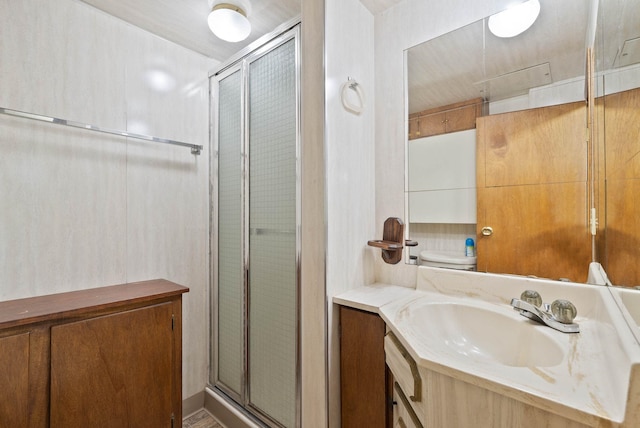 bathroom featuring vanity and a shower stall