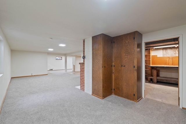 interior space featuring light colored carpet and baseboards