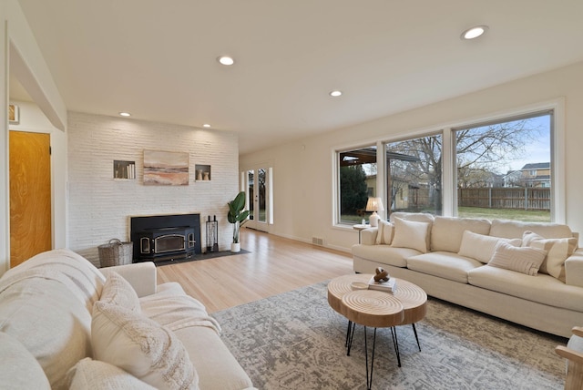 living room with visible vents, recessed lighting, baseboards, and wood finished floors