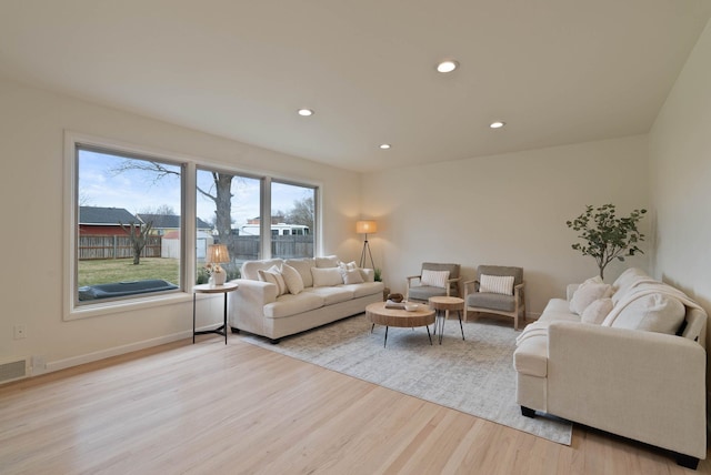 living area featuring recessed lighting, visible vents, light wood finished floors, and baseboards