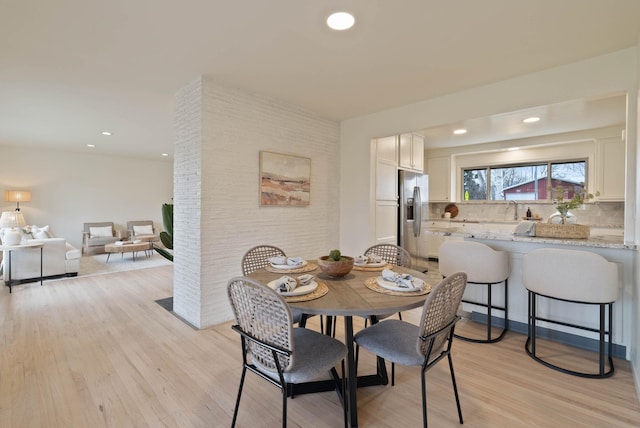 dining area with recessed lighting and light wood-type flooring