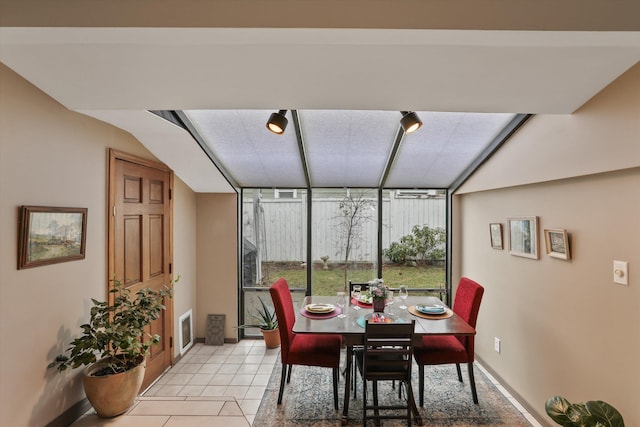 dining area with light tile patterned floors and baseboards