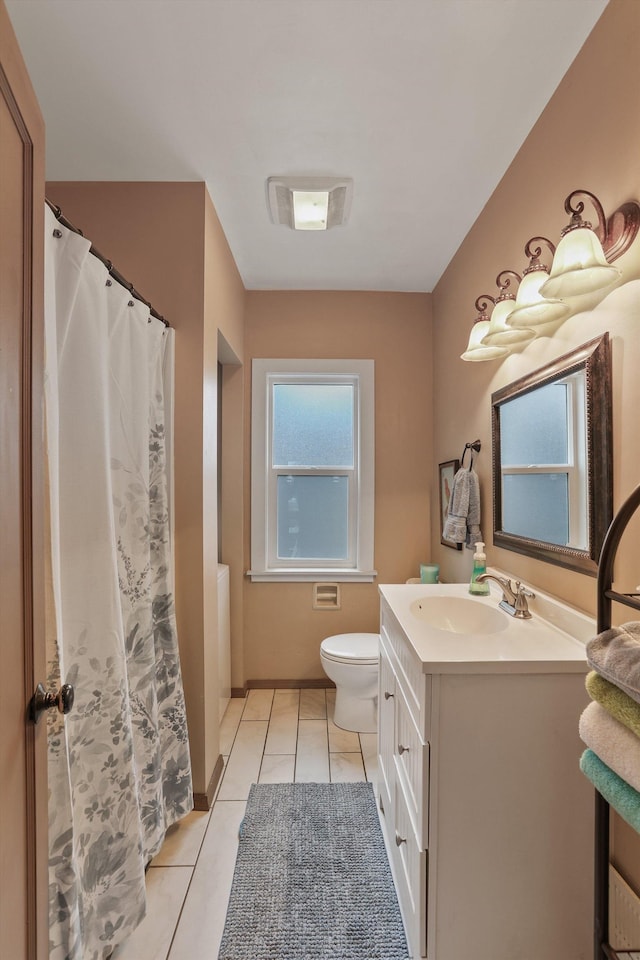 bathroom with tile patterned flooring, visible vents, baseboards, toilet, and vanity