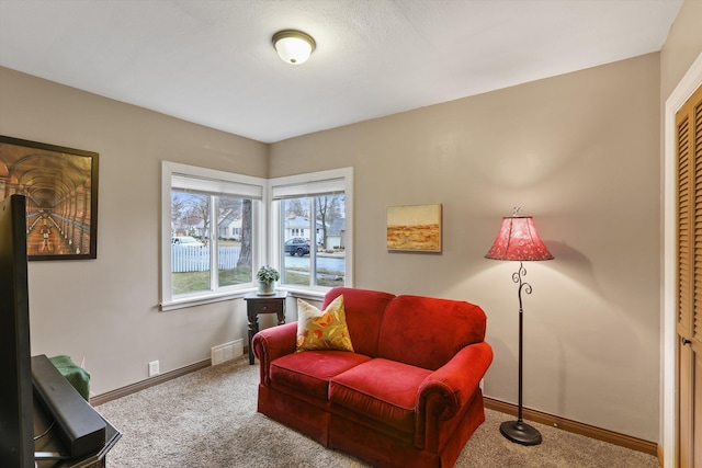 sitting room featuring visible vents, baseboards, and carpet floors