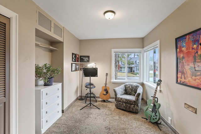 living area with visible vents, baseboards, and carpet flooring