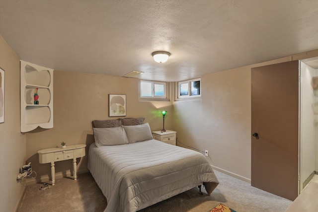 carpeted bedroom with baseboards and a textured ceiling