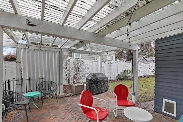 view of patio featuring a grill, a pergola, and fence