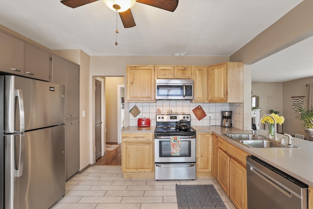 kitchen with visible vents, light brown cabinetry, a sink, appliances with stainless steel finishes, and decorative backsplash