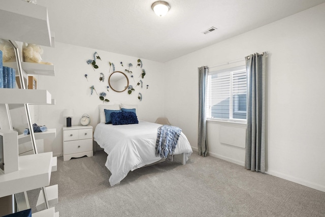 carpeted bedroom with baseboards and visible vents