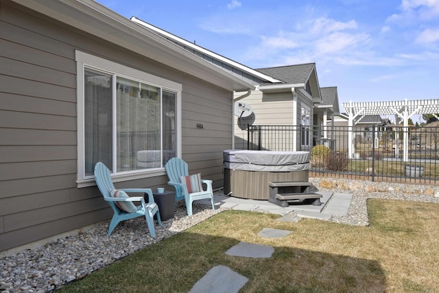 exterior space featuring fence and a hot tub