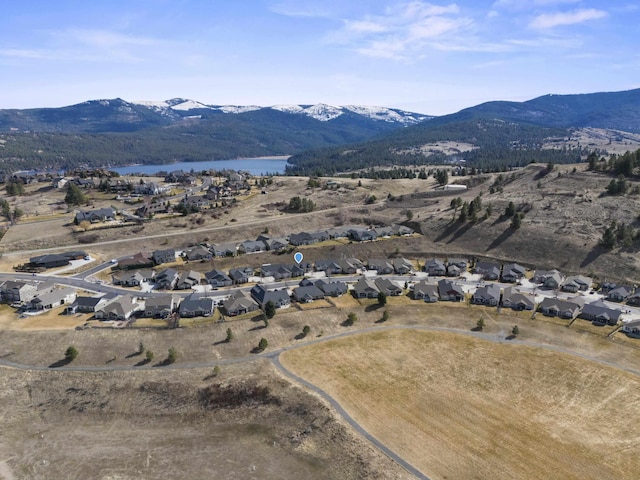 birds eye view of property featuring a residential view and a water and mountain view