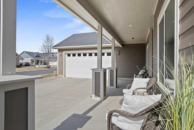 view of patio featuring a garage and driveway