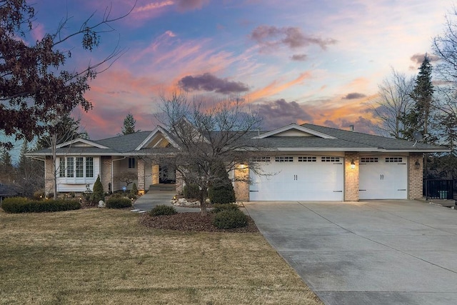 view of front of property featuring a front lawn, an attached garage, and brick siding