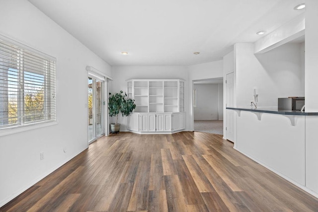 unfurnished living room featuring recessed lighting and dark wood-style flooring