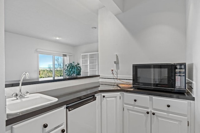 kitchen featuring a sink, dark countertops, dishwasher, and white cabinets