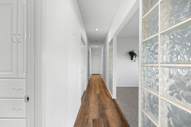 corridor with recessed lighting, baseboards, and wood finished floors