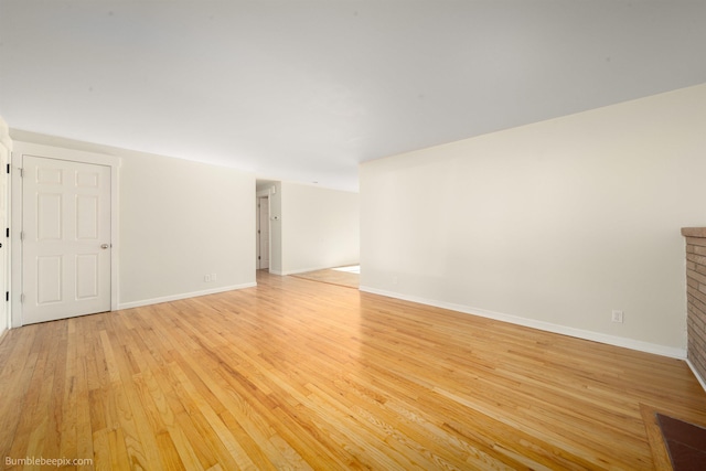 empty room featuring light wood finished floors and baseboards