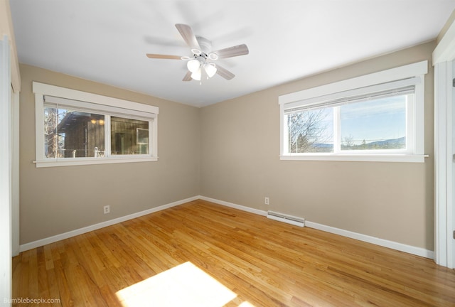 unfurnished room featuring light wood-style flooring, visible vents, and baseboards