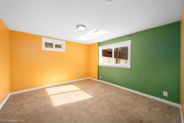 carpeted spare room with baseboards