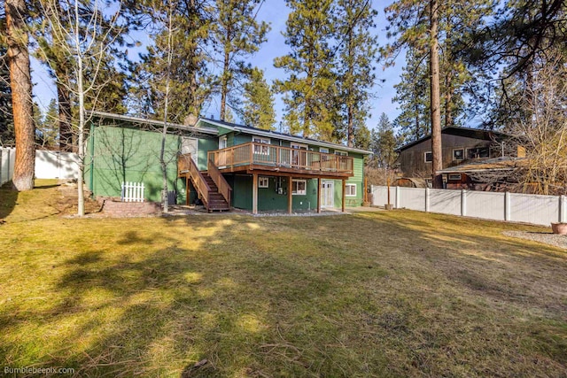 back of house with a fenced backyard, stairway, a yard, and a deck