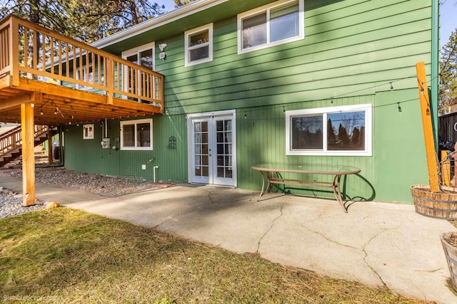 back of property featuring a patio area, stairway, french doors, and a wooden deck