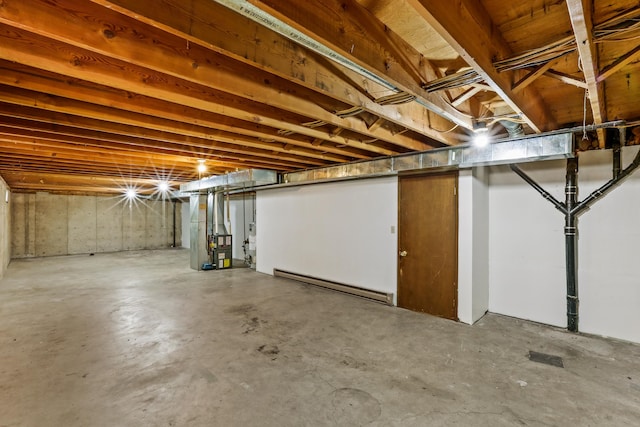 unfinished basement featuring a baseboard heating unit